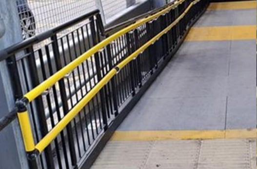 Yellow Lower Intermediate Handrail on a ramp